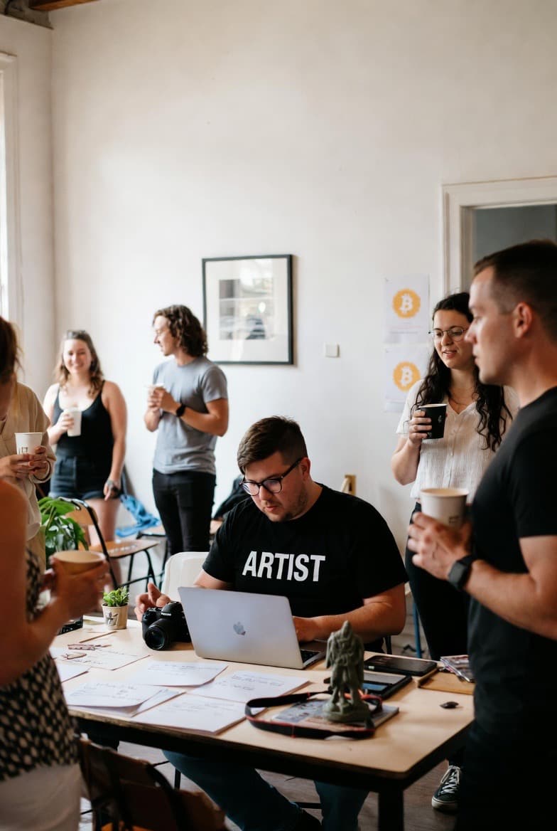 Artists collaborating around a table in a studio.