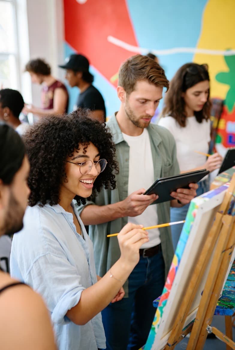 A painting class scene representing creative learning and community.