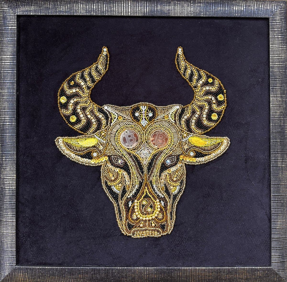 Bullcoin by Aksana Zasinets — hand-embroidered beaded bull with Bitcoin coin eyes on black velvet