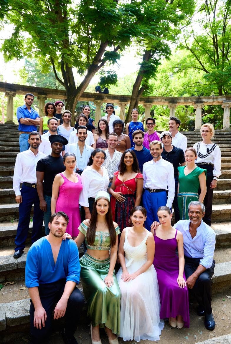 Artists gathered in an outdoor amphitheater, representing residencies and collaborative creation.